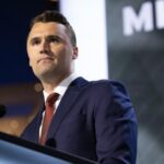 Satire’s Dark Edge: South Park Episode Pulled Over Kirk Tragedy… A man in a suit speaking at a podium during a conference