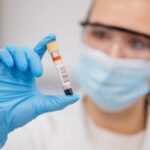 Medical professional holding a blood sample in a laboratory