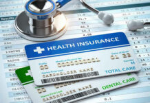 Middle Class Blindsided By ACA Spike Stethoscope and health insurance cards on medical chart.
