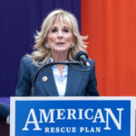 Woman speaking at a podium with a microphone