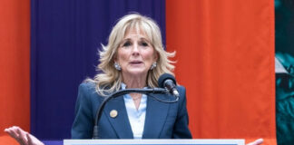 Woman speaking at a podium with a microphone