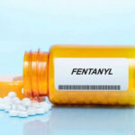 Orange pill bottle labeled Fentanyl with white pills.