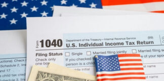 U.S. tax forms with a small American flag and dollar bills