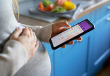 Video Call Abortions? Alaska Draws a Line Pregnant woman checking a pregnancy app on a smartphone
