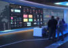 License REVOCATION Threats Rock Big Media Cybersecurity command center with large digital display screens.