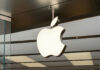 Illuminated Apple logo inside a store.