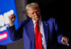 Is Trump’s Crypto Wealth A Problem? Man in blue suit with red tie speaking