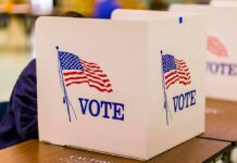 Top Democrat Admits Voter ID Wins voting booth with American flag graphics