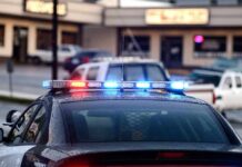 Police Surveillance Abuse Exposed Across Georgia Police car with flashing red and blue lights in a parking lot