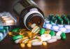 Illegal Prescription Pills Sold In Plain Sight Assorted pills and capsules spilling from a brown bottle