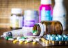 Washington Halts California Medicaid Funding Medicine pills and syringe on table with brown bottle