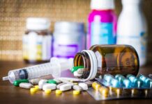Washington Halts California Medicaid Funding Medicine pills and syringe on table with brown bottle