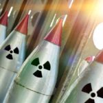 Nuclear warheads lined up with radiation symbols.