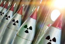 Nuclear warheads lined up with radiation symbols.