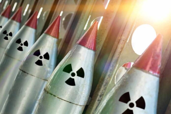 Nuclear warheads lined up with radiation symbols.