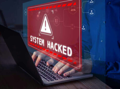 System Hacked warning on laptop screen.