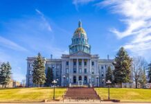 State capitol building with golden dome under blue sky.