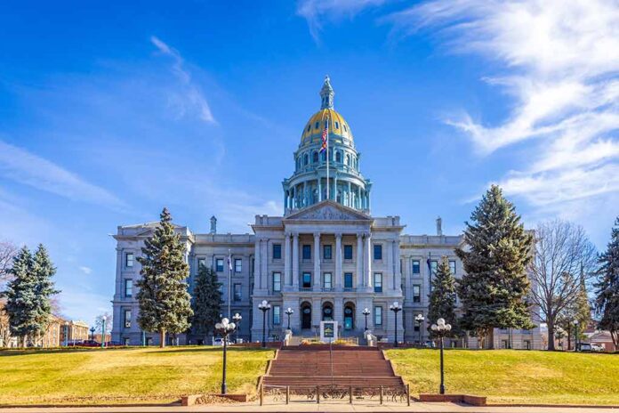 State capitol building with golden dome under blue sky.