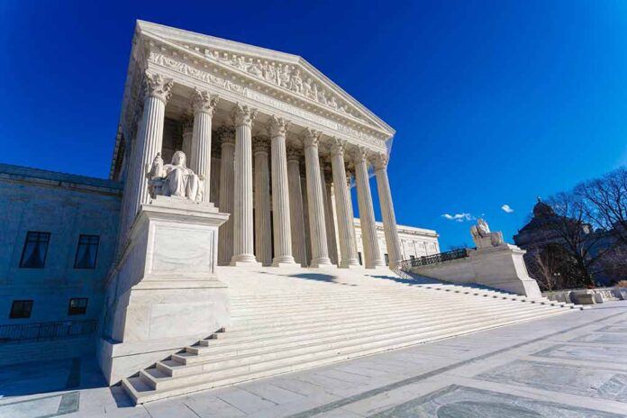 Supreme Court building with columns and statues.