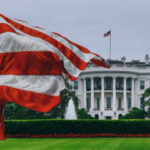 U.S. flag waving in front of the White House.