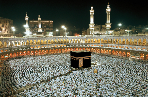 Crowd of worshippers around the Kaaba in Mecca at night.