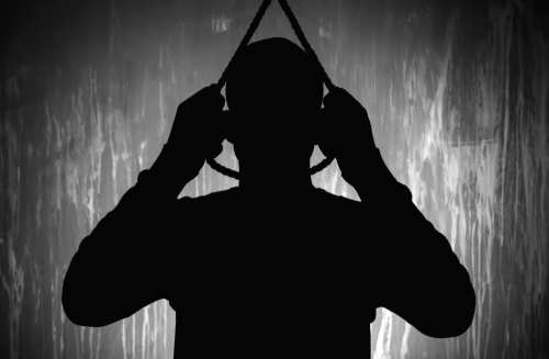 Silhouette of person holding a noose overhead.