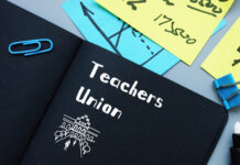 Notebook labeled "Teachers Union" with office supplies.