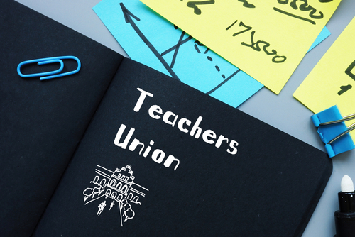 Notebook labeled "Teachers Union" with office supplies.