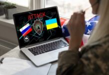 Laptop displaying ATTACK with Russian and Ukrainian flags