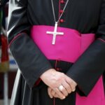 Close-up of a cleric with cross necklace.