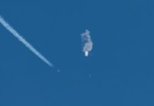 Aircraft intercepting an airborne object releasing smoke.