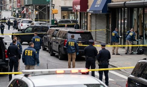 FBI agents and police officers at a crime scene with police tape