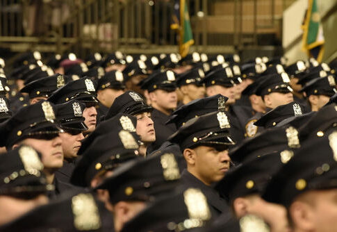 A large group of police officers in uniform standing in formation