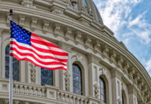 U.S. flag in front of the Capitol building.